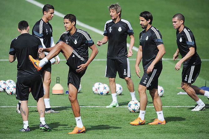 Raphael Varane of Real Madrid warms up with Cristiano Ronaldo, Fabio Coentrao, Sami Khedira and Pepe during the Real Madrid training session at Valdebebas grounds ahead of the UEFA Champions League second leg quarter-final, in Madrid on Tuesday
