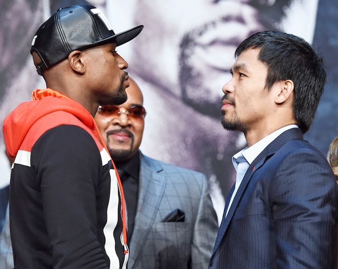 Floyd Mayweather Jr. (L) and WBO welterweight champion Manny Pacquiao