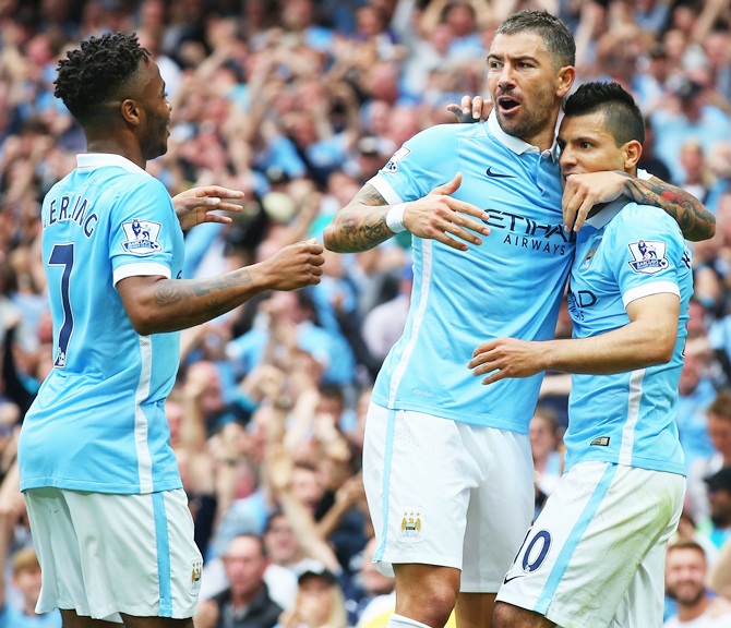 Sergio Aguero of Manchester City celebrates scoring the opening goal with Aleksandar   Kolarov and Raheem Sterling 