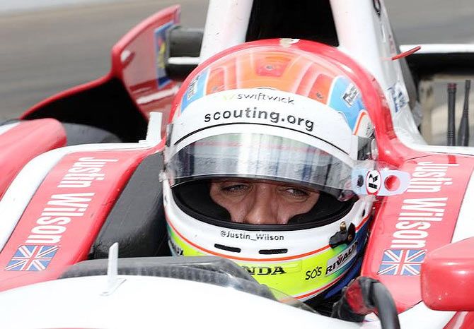 IndyCar Series driver Justin Wilson sits in his car during practice for the 2014 Indianapolis 500 at Indianapolis Motor Speedway