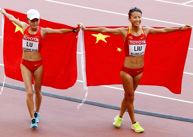 China's silver medalist Xiuzhi Lu, left, and gold medalist Hong Liu celebrate   after the Women's 20km Race Walk final