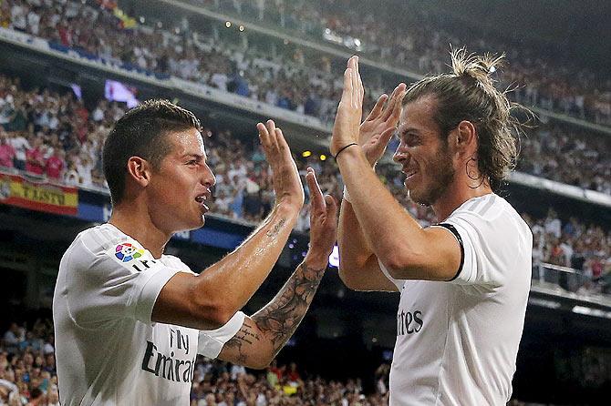 Real Madrid's James Rodriguez (left) celebrates with teammate Gareth Bale after his goal against Real Betis during their La Liga match at Santiago Bernabeu stadium in Madrid on Saturday