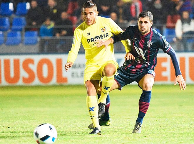A Villareal and a Huesca player vie for possession during their King's Cup Copa Del Rey match on Thursday
