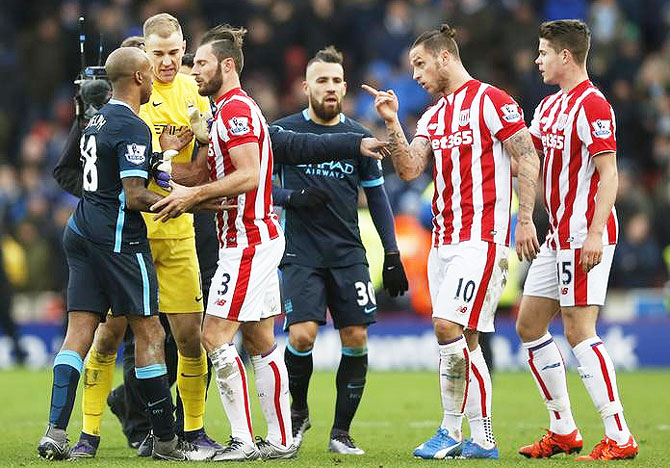 Stoke City's Marko Arnautovic (right) clashes with Manchester City's Fabian Delph after the game as Erik Pieters and Joe Hart interject