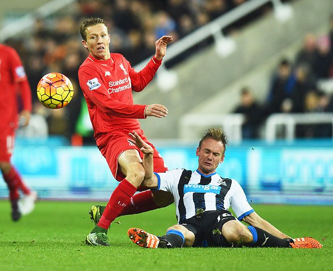 Newcastle's Siem de Jong goes to ground during a challenge against Liverpool's Lucas Leiva