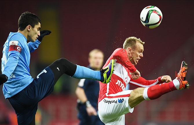 FC Spartak Moscow's Denis Glushakov (right) is challenged by FC Krylia Sovetov Samara's Ibragim Tsallagov during their Russian Premier League match at the Arena Otkritie Stadium in Moscow on December 04