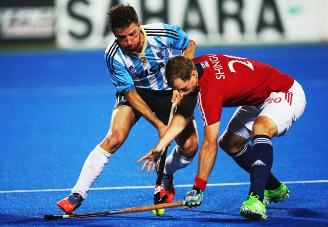 Argentina's Manuel Brunet vies with Great Britain's Dan Shingles during their Hero Hockey League World Final match at the Sardar Vallabh Bhai Patel International Hockey Stadium in Raipur on December 04