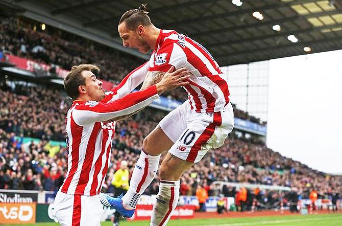 Marko Arnautovic celebrates with Xherdan Shaqiri after scoring the first goal for Stoke City against Manchester City at the Britannia Stadium on Saturday