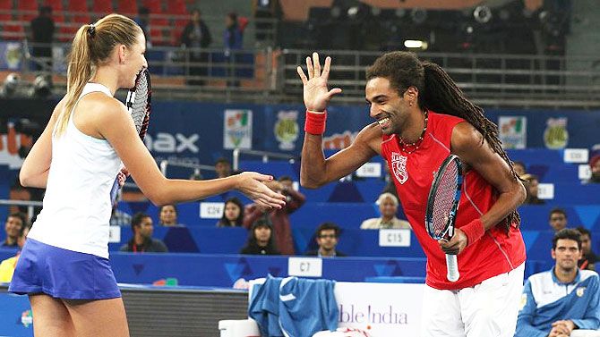 Singpore Slammers' Dustin Brown and Kristina Pliskova celebrate after their win over Kirsten Flipkens and Leander Paes during the International Premier Tennis League (IPTL) match at the IG Stadium in New Delhi on Saturday.