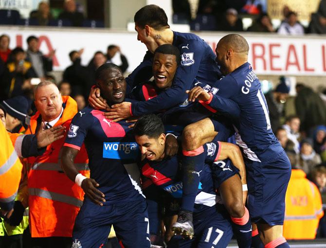 Ayoze Perez of Newcastle United (17) is mobbed in celebration by teammates as he scores their second goal during their Barclays English Premier League match against Tottenham Hotspur at White Hart Lane in London on Sunday