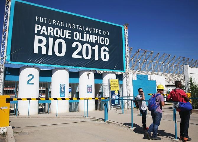  Workers stand at an entrance to the Olympic Park construction