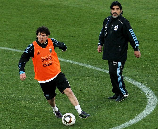 Argentina's head coach Diego Maradona watches on as Lionel Messi goes through the grind at a team training session in Pretoria on June 6, 2010