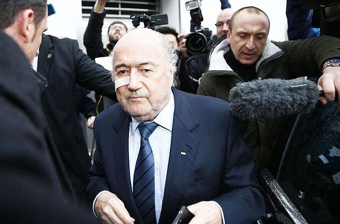 FIFA President Sepp Blatter is surrounded by media as he arrives for a news conference in Zurich on Monday
