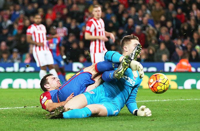 Crystal Palace's James McArthur and Stoke's Jack Butland are caught in a tangle as they vie for possession during their English Premier League match at Britannia Stadium on Saturday