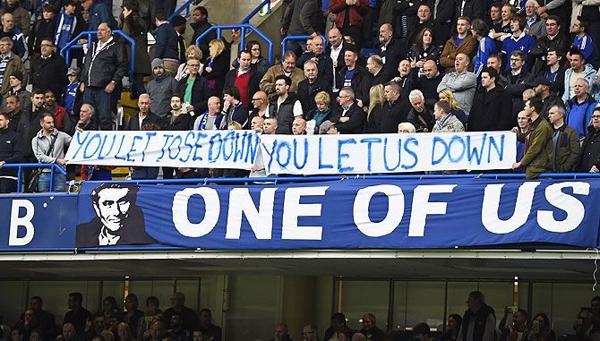 Chelsea fan holds up banners for Jose Mourinho during their match against Sunederland at Stamford Bridge in London on Saturday