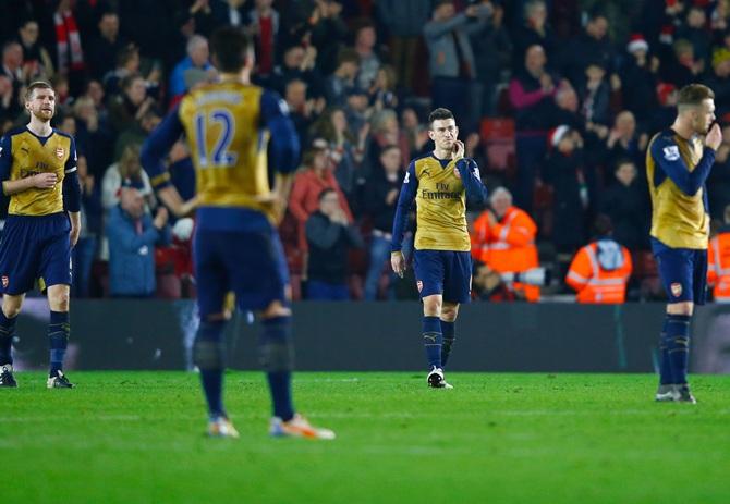 Central defenders Per Mertesacker, left, and Laurent Koscielny of Arsenal, second right, look dejected 