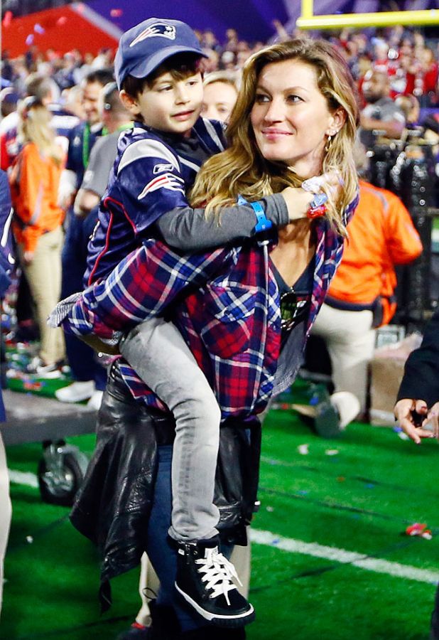 Brazilian supermodel Gisele Bundchen, wife of Tom Brady of the New England Patriots, walks on the field with their son, Benjamin after the Super Bowl XLIX