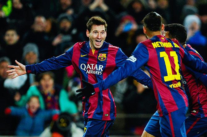 FC Barcelona's Lionel Messi celebrates with teammate Neymar after scoring his team's third goal against Villarreal CF during the La Liga match at Camp Nou on Sunday