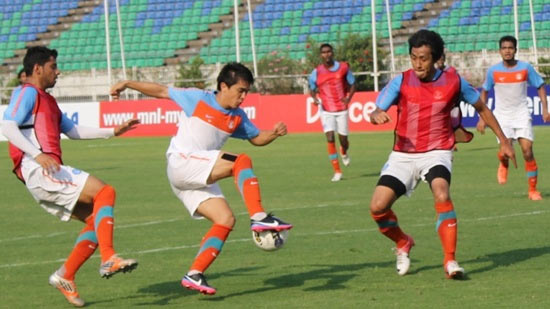 Sunil Chhetri (middle) tries to sidestep Gouramangi Singh as Gurjinder Kumar (left) presses from behind during a team training session 