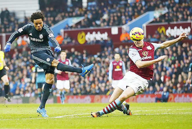 Loic Remy of Chelsea shoots past Ciaran Clark Aston Villa during their English Premier League match at Villa Park, Birmingham on Saturday