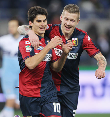 Genoa CFC's Diego Perotti (left) celebrates with teammate Juraj Kucka after scoring the opening goal from the penalty spot during their Serie A match at Stadio Olimpico in Rome on Monday