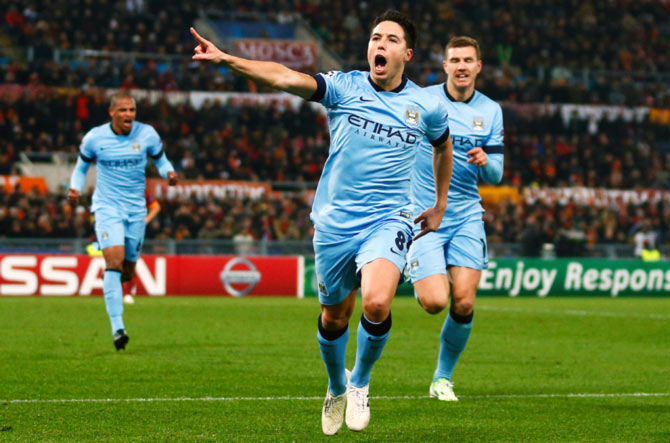 Samir Nasri (centre) celebrates after scoring the first goal for Manchester City