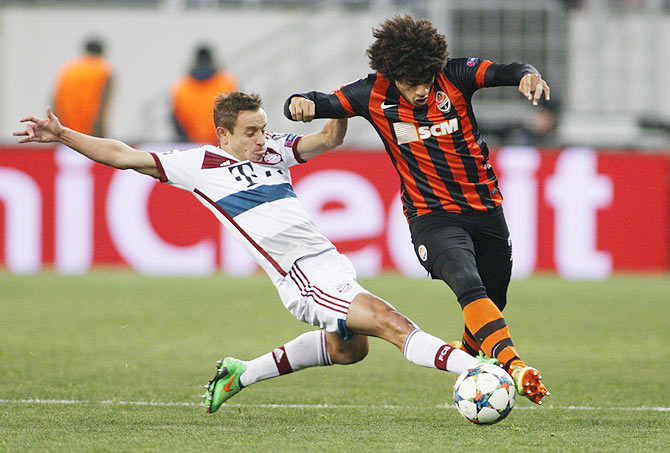 Shakhtar Donetsk's Taison (right) fights for the ball with Bayern Munich's Rafinha during their Champions League round of 16 first leg match in Lviv, Ukraine on Tuesday