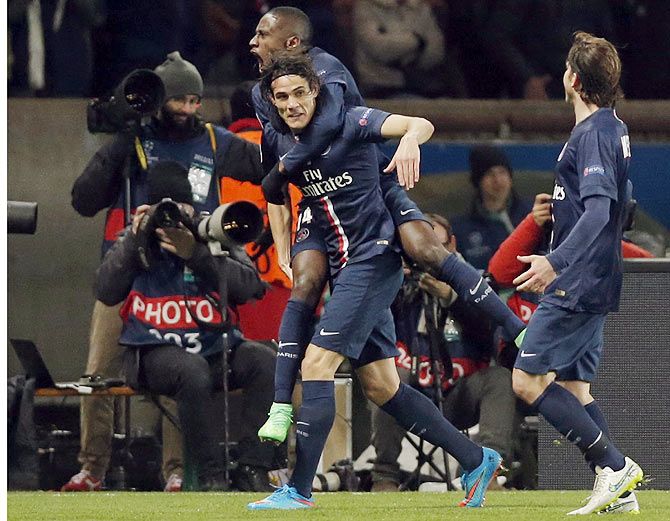 Paris St Germain's Edinson Cavani (left) celebrates with teammate Blaise Matuidi after scoring the equaliser against Chelsea during their Champions League Round of 16 first leg match at the Parc des Princes Stadium in Paris on Tuesday