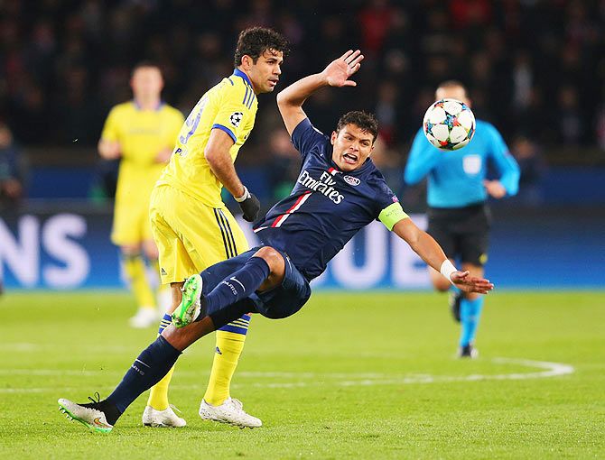 Thiago Silva of Paris Saint-Germain is challenged by Diego Costa of Chelsea