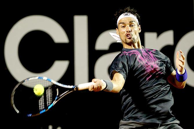 Fabio Fognini returns a shot to Rafael Nadal \