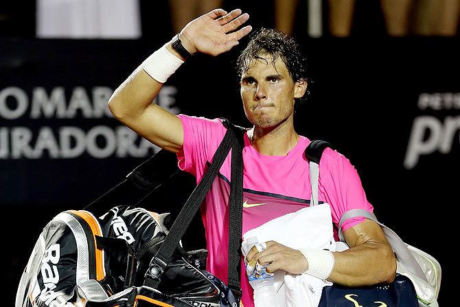 Rafael Nadal of Spain leaves the court after losing to Fabio Fognini of Italy during the Rio Open at the Jockey Club Brasileiro on Saturday