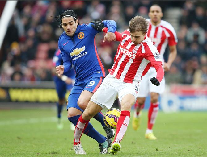 Manchester United's Radamel Falcao and Stoke City's Marc Muniesa vie for posession during their English Premier League match at Britannia Stadium in Stoke-on-Trent on Thursday