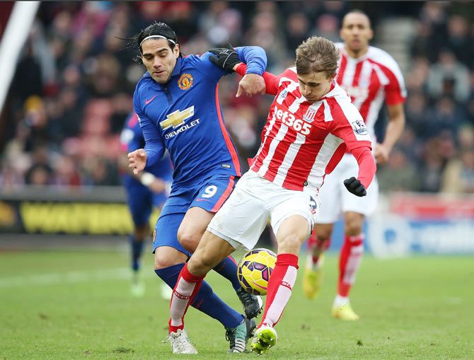 Manchester United's Radamel Falcao and Stoke City's Marc Muniesa vie for posession during their English Premier League match at Britannia Stadium in Stoke-on-Trent on Thursday