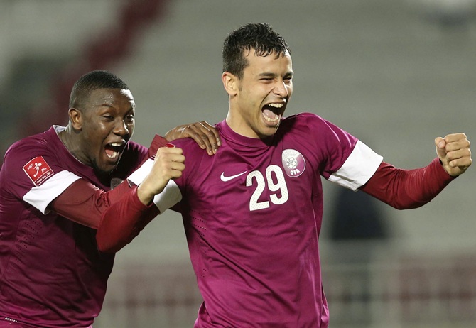 Qatar's Boualem Khoukhi, right celebrates with Mohammed Musa