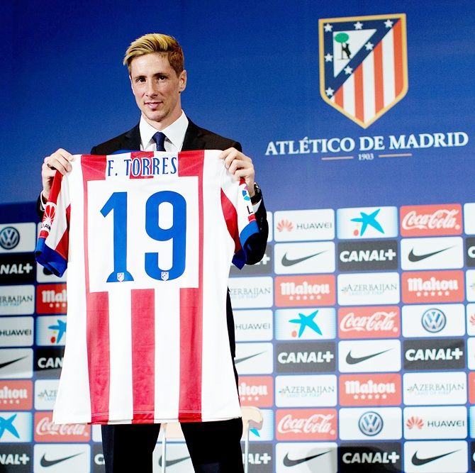Fernando Torres poses with his new shirt during his presentation as the new Club Atletico de Madrid 