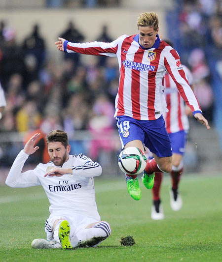 Fernando Torres (R) of Club Atletico de Madrid gets past Sergio Ramos of Real Madrid during their Copa del Rey King's Cup round of 16, first leg match at Vicente Calderon Stadium in Madrid on Wednesday