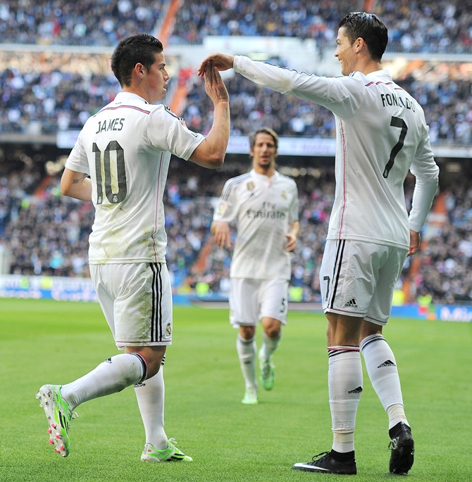James Rodriguez of Real Madrid celebrates with Cristiano Ronaldo after scoring Real's opening goal 