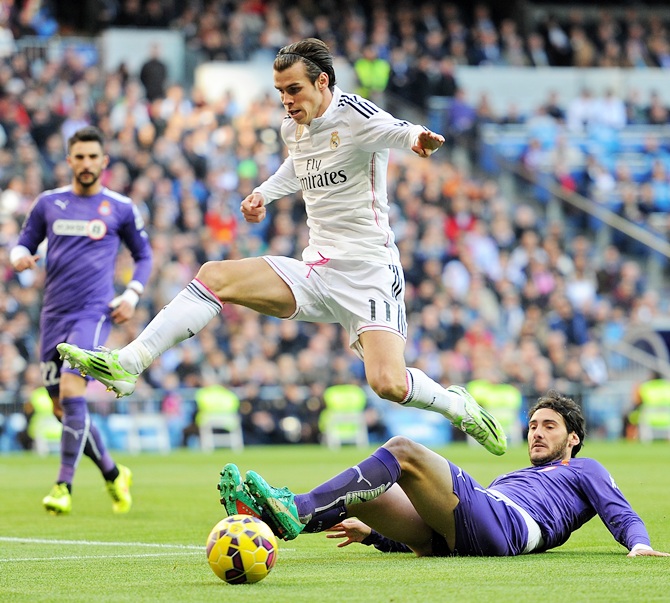 Gareth Bale of Real Madrid jumps over Anaitz Arbilla of RCD Espanyol 