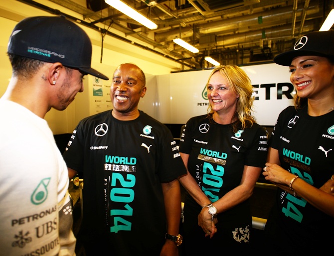 Lewis Hamilton of Great Britain and Mercedes GP celebrates with his father Anthony Hamilton next to his stepmother Linda Hamilton and girlfriend Nicole Scherzinger