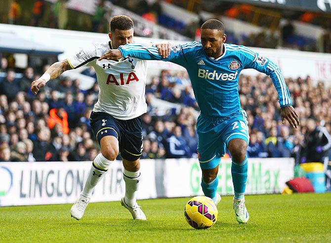 Jermain Defoe of Sunderland takes on Kyle Walker of Tottenham Hotspur during their English Premier League match at White Hart Lane on Saturday