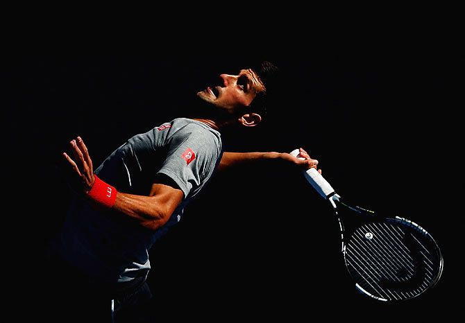 Novak Djokovic of Serbia serves during a practice session 