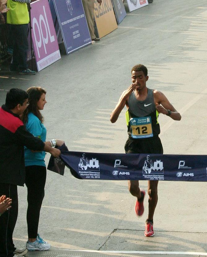 Ethiopian Tesfaye Abera crosses the finish line at the Mumbai Marathon on Sunday