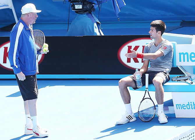 Novak Djokovic of Serbia talks to coach Boris Becker during a practice session at Melbourne Park on Sunday