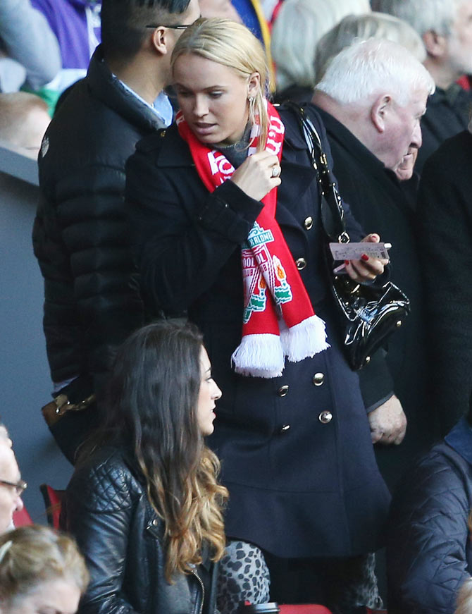 Tennis player Caroline Wozniacki takes her seat during the English Premier League match between Liverpool and West Bromwich Albion at Anfield in Liverpool on October 26, 2013