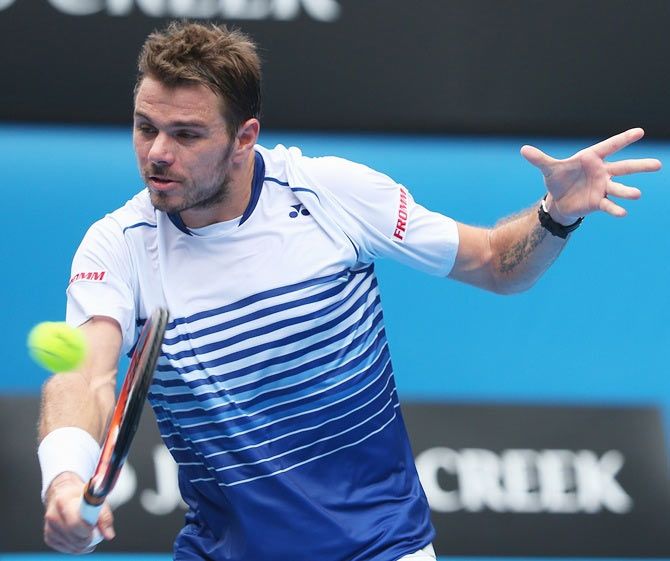Stanislas Wawrinka of Switzerland plays a backhand in his first round match against Marsel Ilhan of Turkey