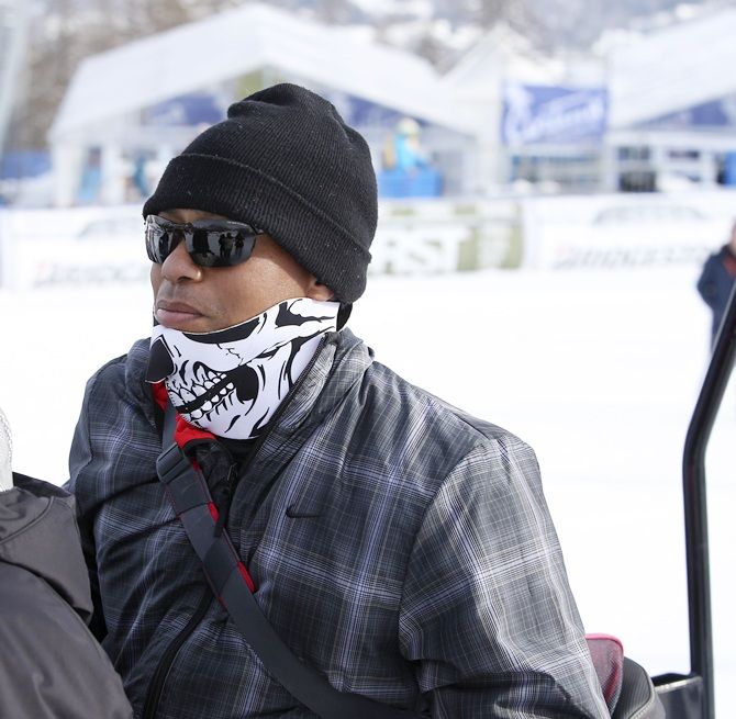 US golfer Tiger Woods sits on a snow bike during the women's World Cup Super-G skiing race in Cortina   D'Ampezzo