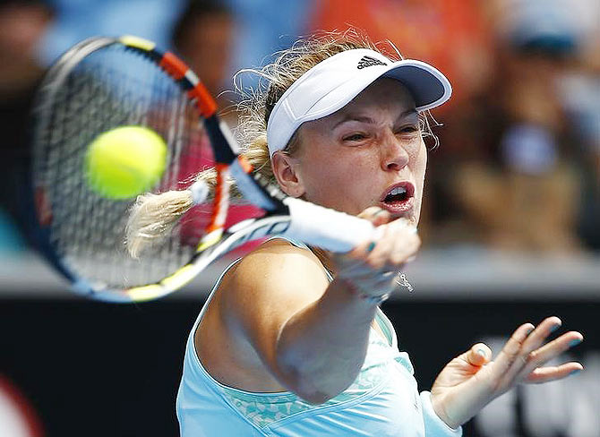 Caroline Wozniacki of Denmark hits a return against Taylor Townsend of the US