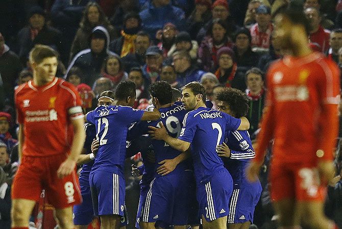  Chelsea players celebrate Eden Hazard's goal as Liverpool players wear a dejected look
