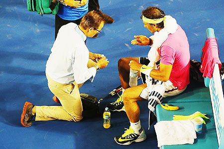 Rafael Nadal of Spain talks to his doctors in his second round match against Tim Smyczek of USA during day three of the 2015 Australian Open on Wednesday