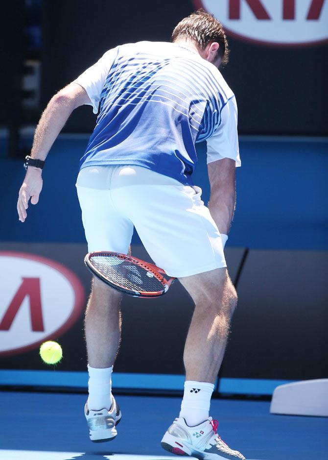 Stanislas Wawrinka of Switzerland hits the ball between his legs during his second round match against Marius Copil of Romania